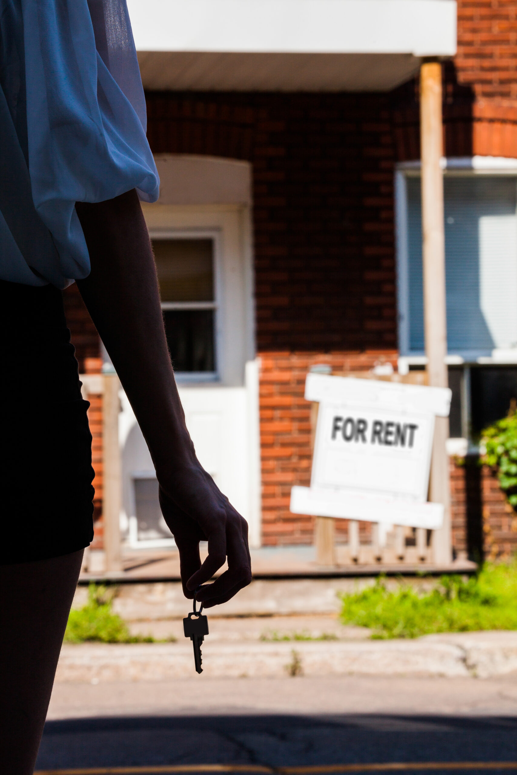 Young Woman standing in front of her new apartment